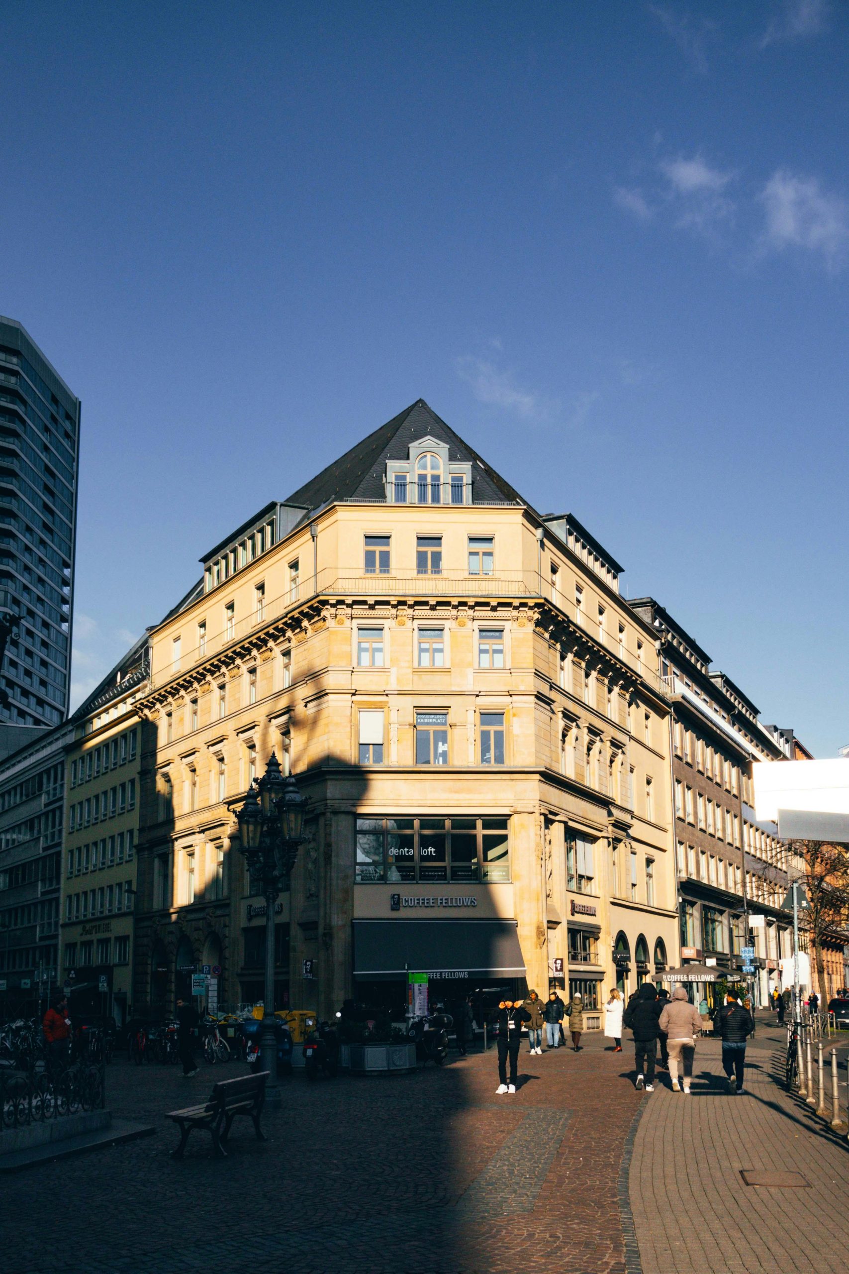 Sunlit view of a historic building in Frankfurt's city center, capturing city life.